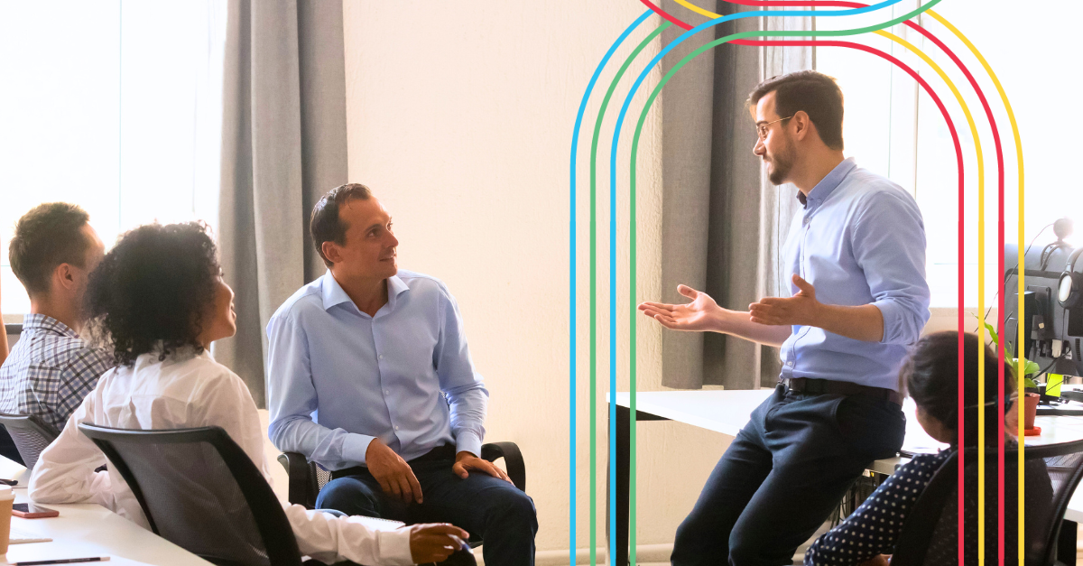 Leader having a conversation with team members at work. 