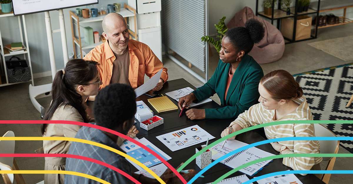 Five people sitting around a table in discussion.