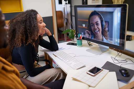 Woman chatting with another woman in a virtual meeting