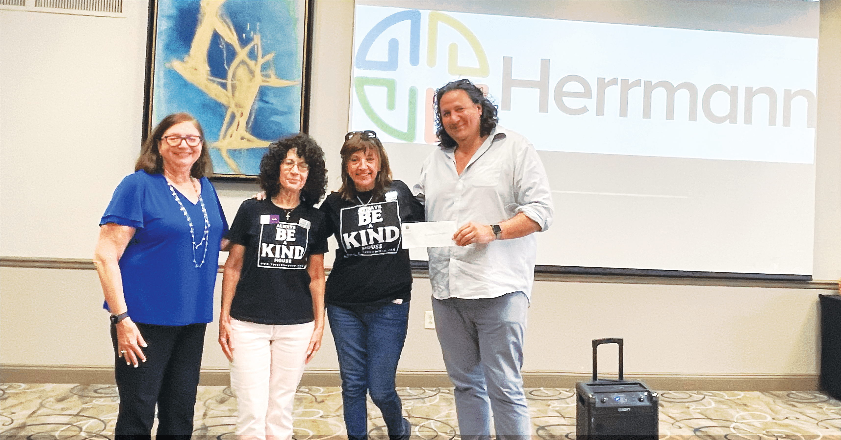 Team members posing together in front of a presentation