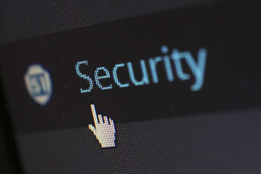 Cursor on laptop clicking on 'Security'