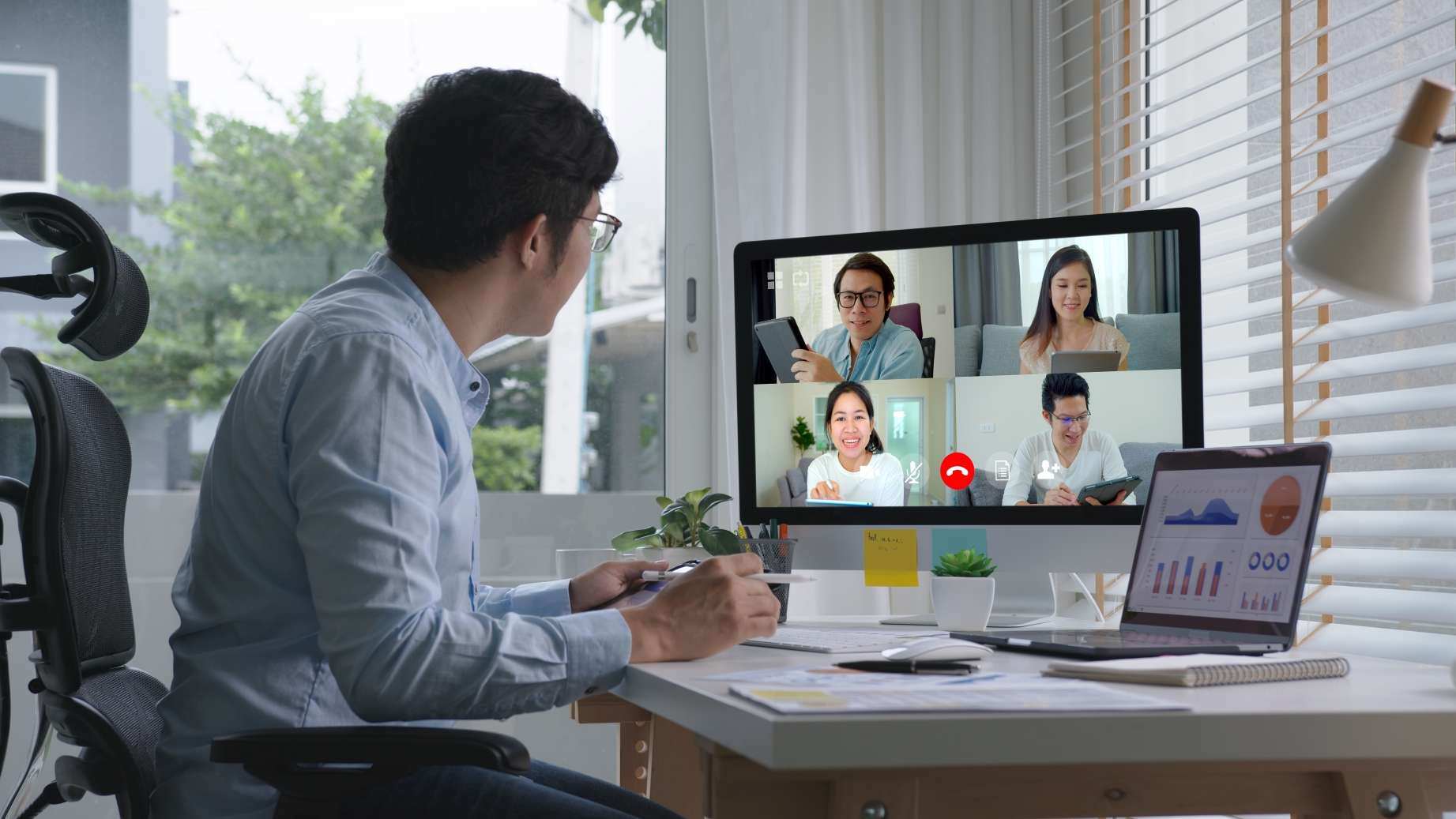 Man in a virtual meeting at a home office