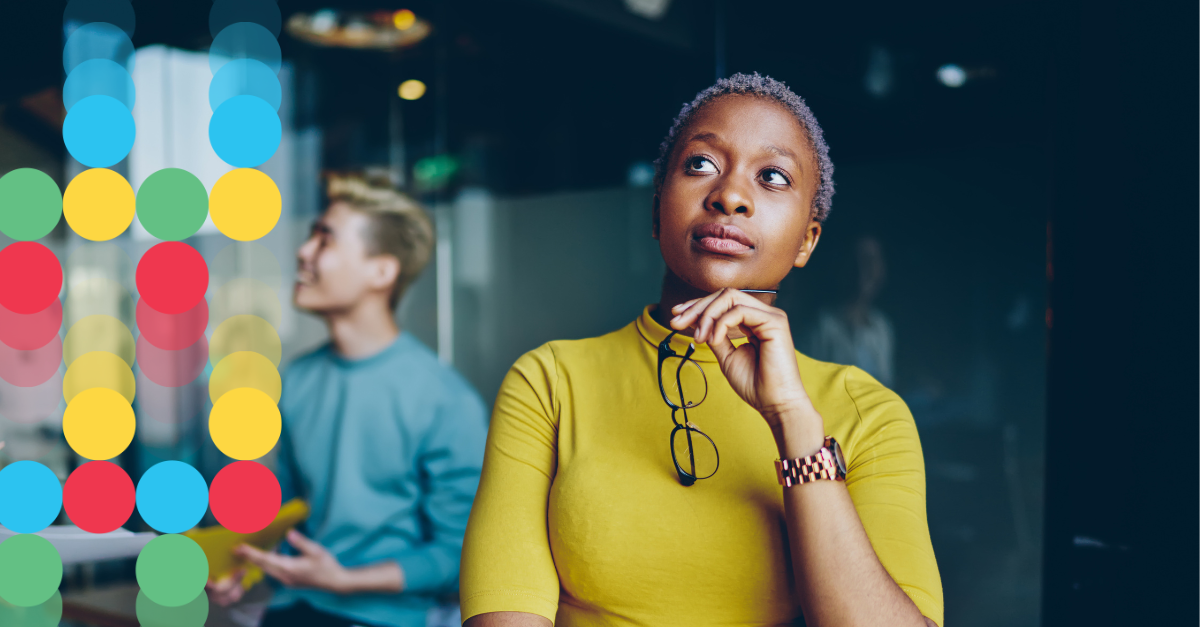 Woman wearing a yellow turtleneck deep in thought