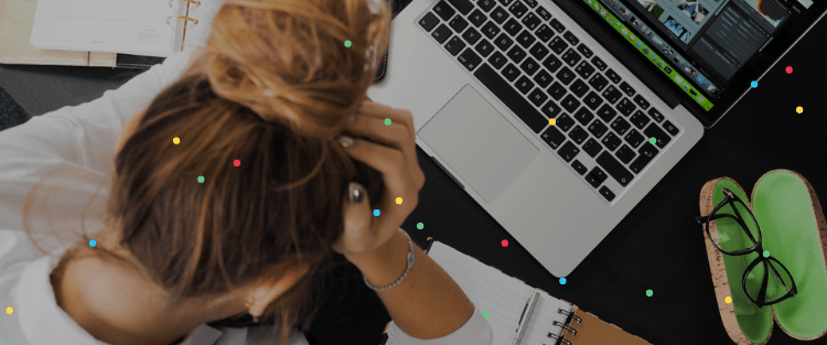 Woman leaning over her laptop deep in thought